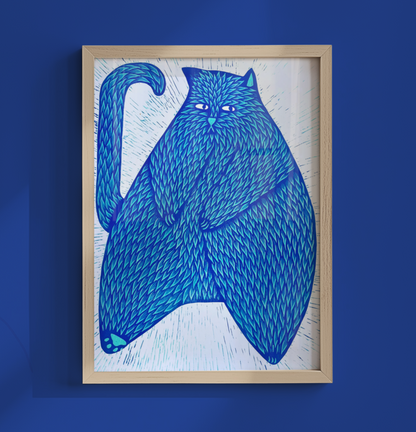 A framed art print featuring a stylized blue cat illustration on a white background, mounted on a solid blue wall.